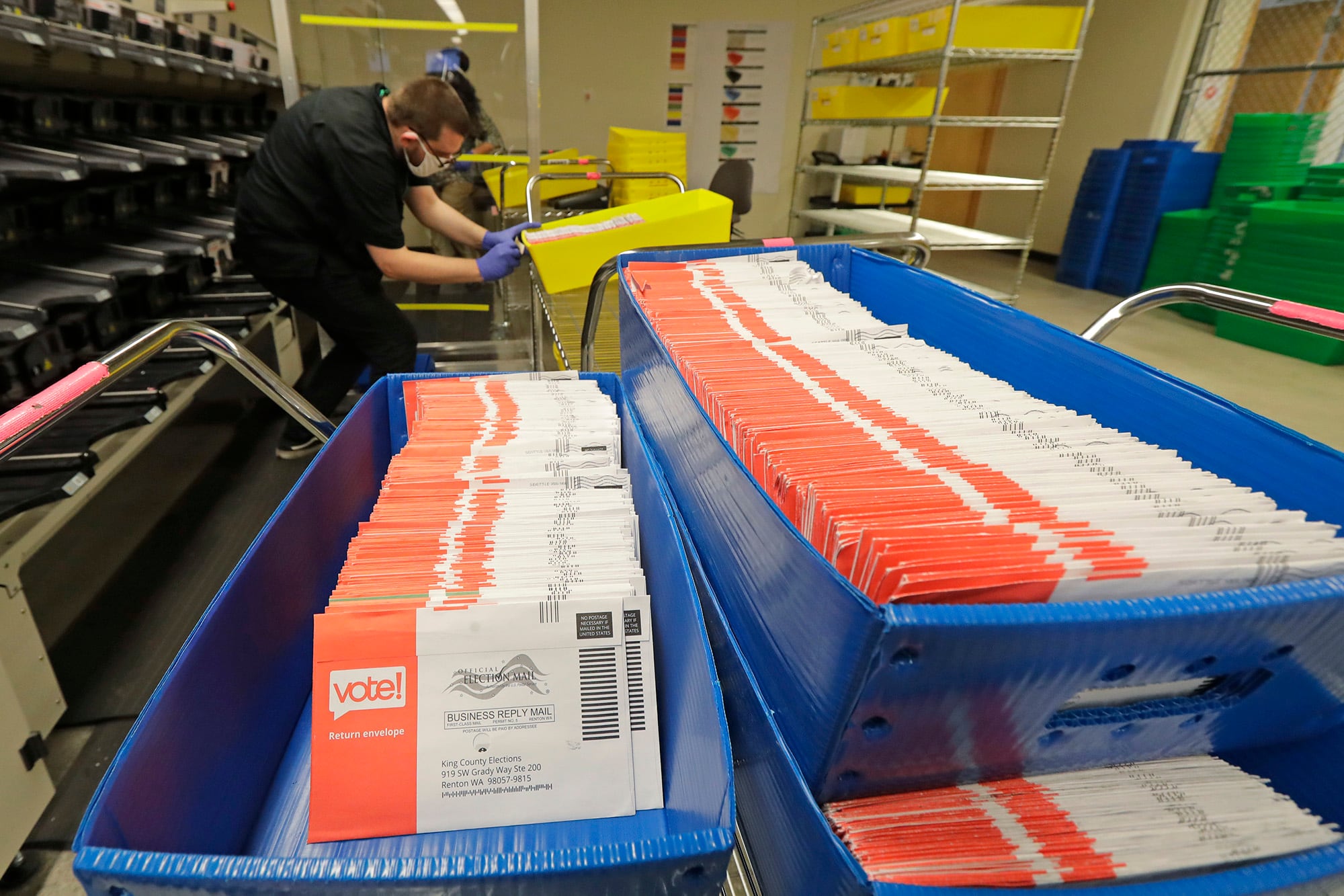 Vote-by-mail ballots are shown in sorting trays on Aug. 5, 2020, at the King County Elections headquarters in Renton, Wash., south of Seattle.