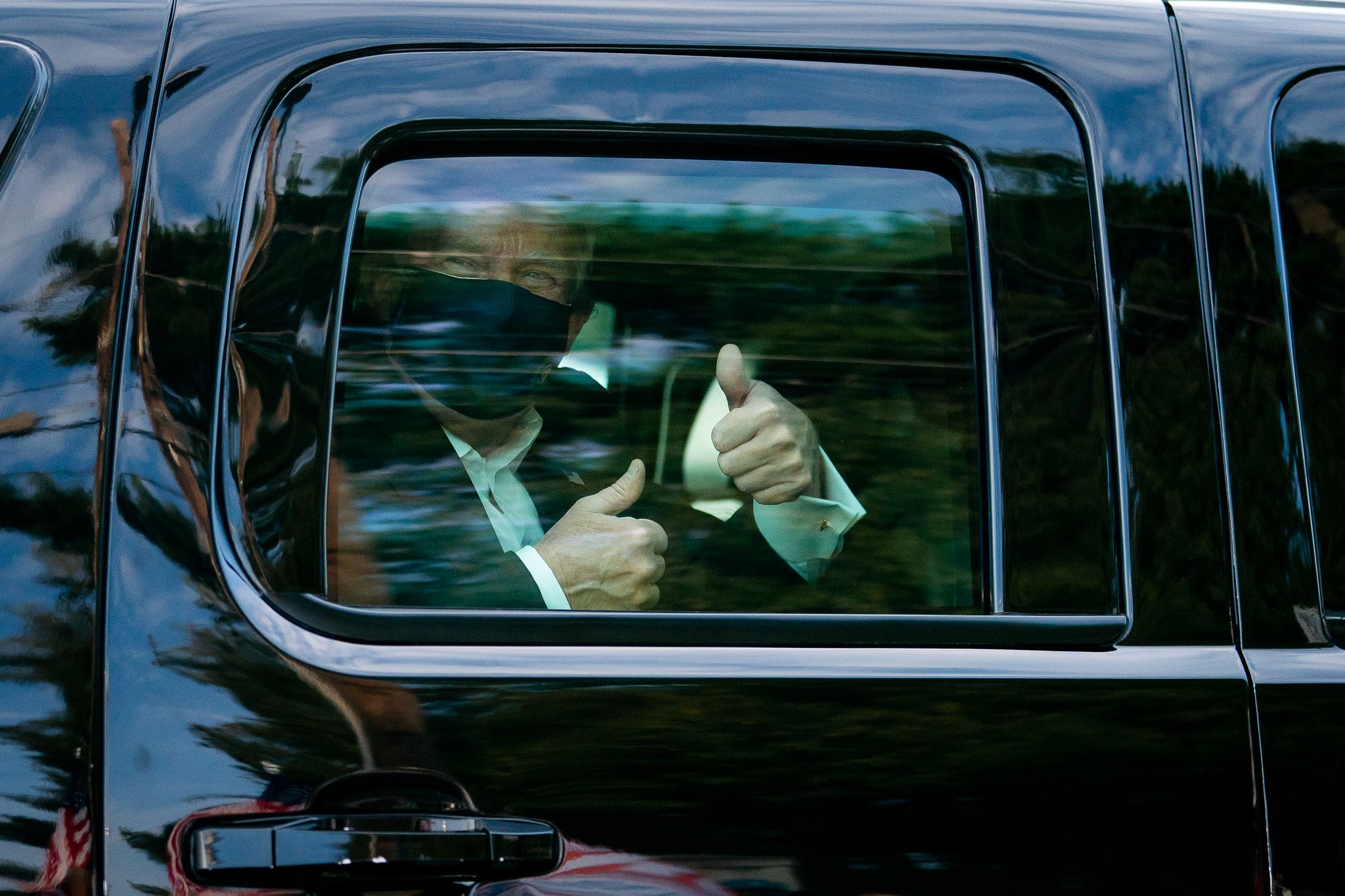 President Donald Trump greets supporters during a drive by outside of Walter Reed National Military Medical Center on Oct. 4, 2020, in Bethesda, Md.