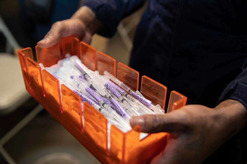 Covid-19 vaccine syringes are transported aboard the Wasp-class amphibious assault ship USS Kearsarge (LHD 3) March 31, 2021. (Mass Communication Specialist 3rd Class Jake Vermeulen/Navy)