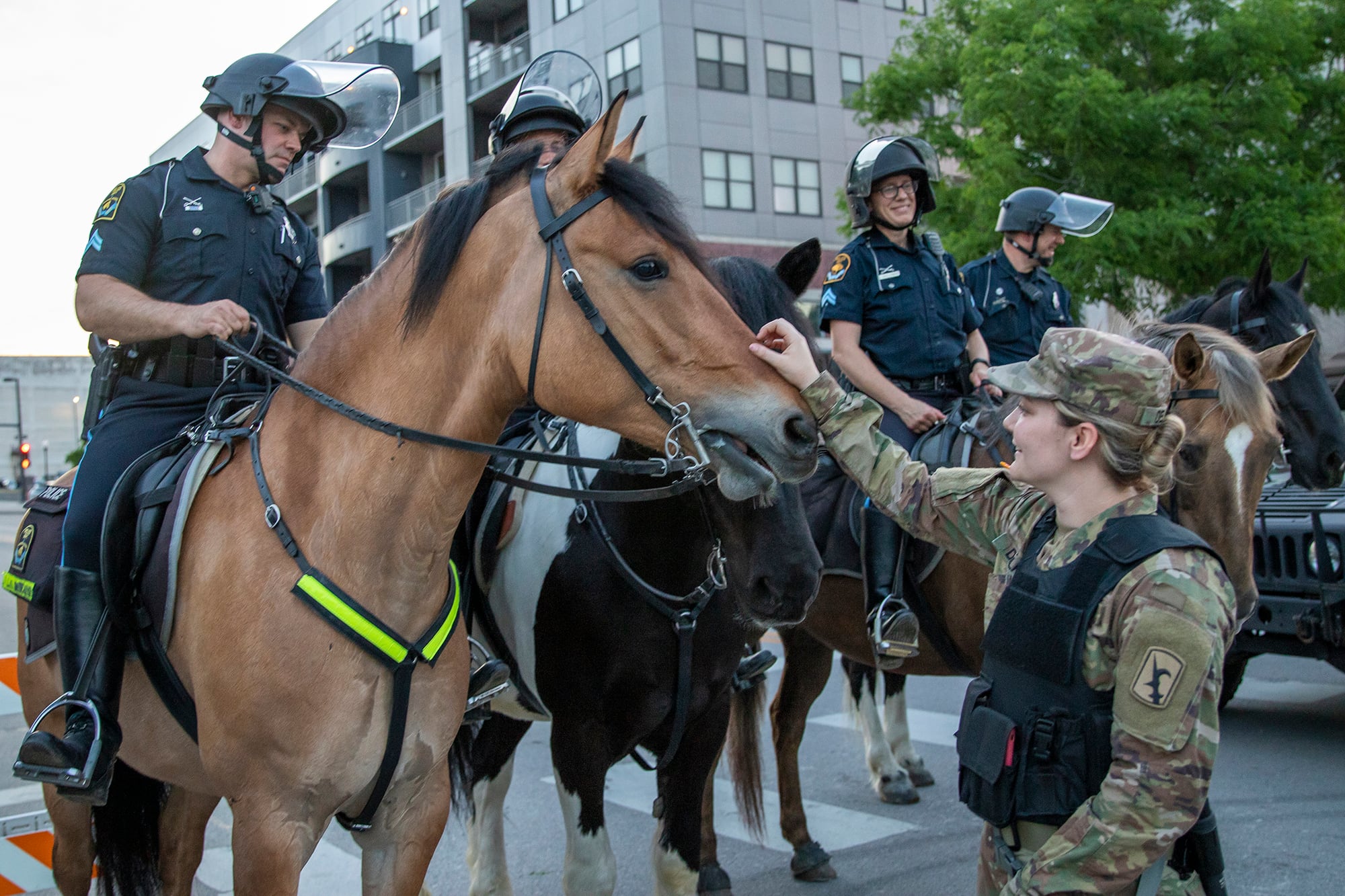 Soldiers with the Nebraska Army National Guard engage with Omaha Police Mounted Patrol Unit officers and their horses June 2, 2020, in downtown Omaha.