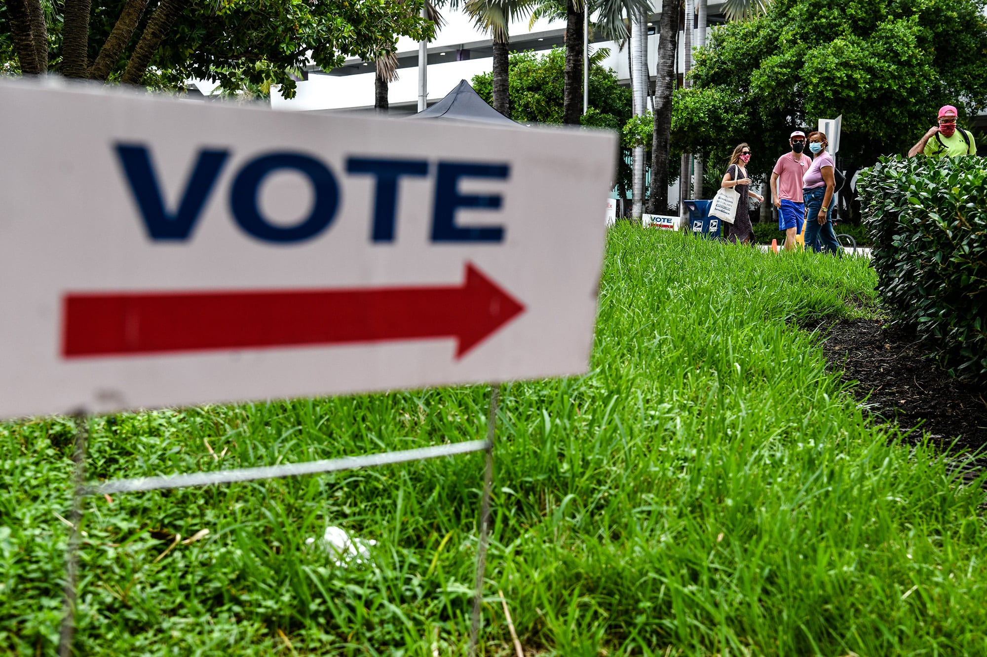 Voters wait in line to cast their early ballots at Miami Beach City Hall in Miami Beach, Fla., on Oct. 20, 2020.