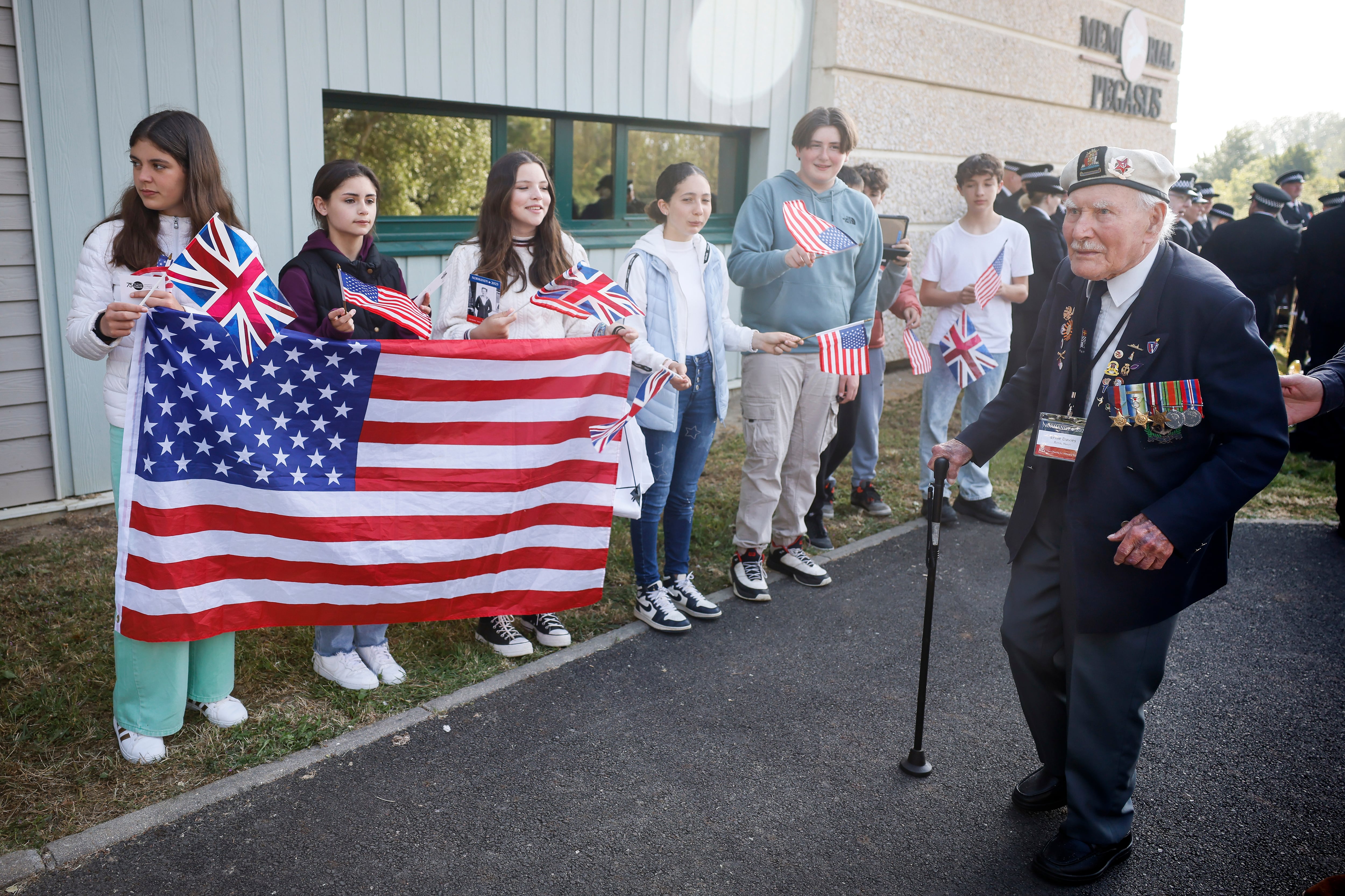 Children greet war veterans arriving for ceremony at the Pegasus Bridge memorial in Benouville, Normandy, Monday June 5, 2023.