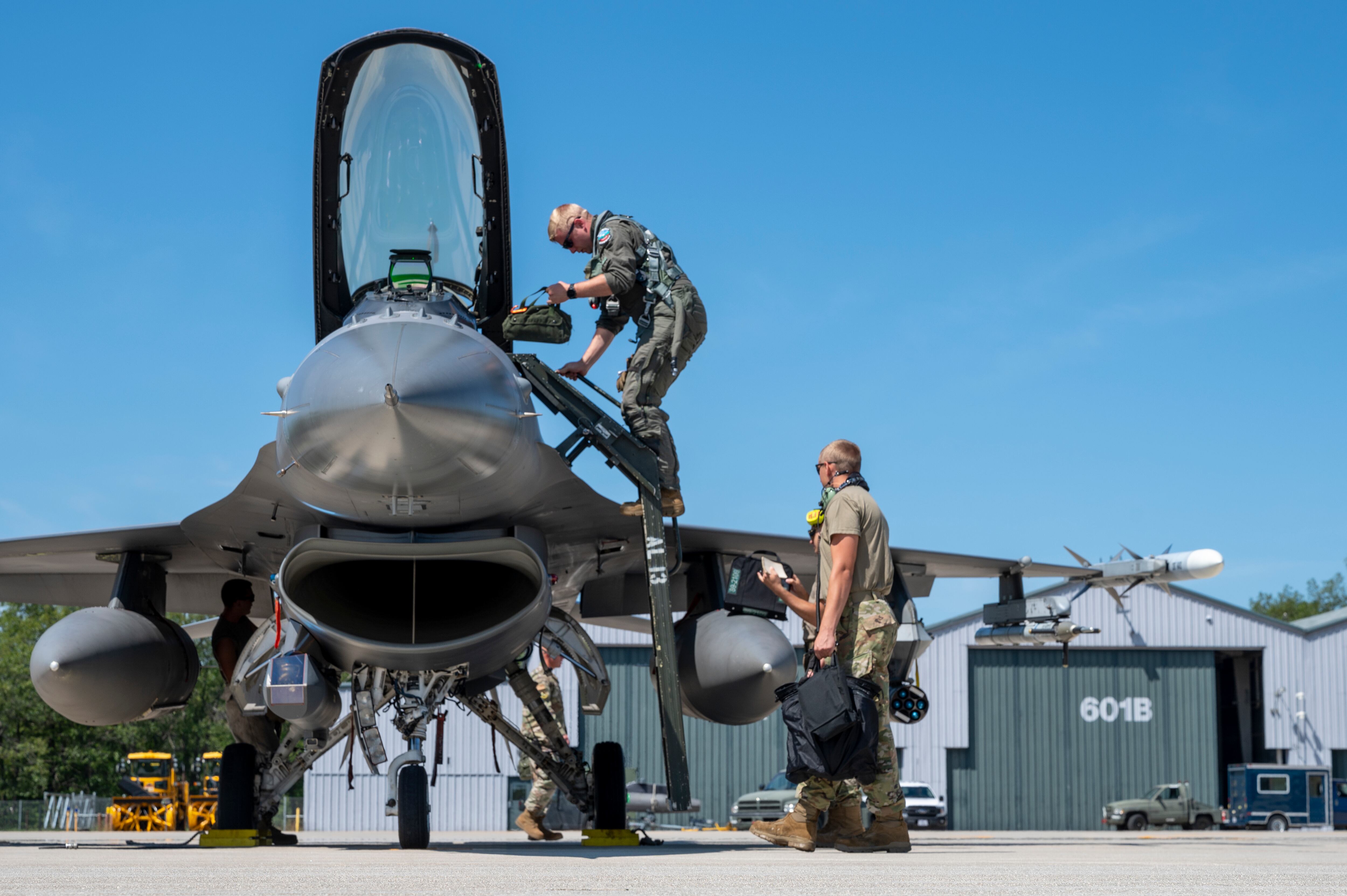 Ohio Air National Guard Capt. Travis Dancer exits his aircraft after landing at Alpena Combat Readiness Training Center in Michigan during the Global Information Dominance Experiment 3 in July 2021.