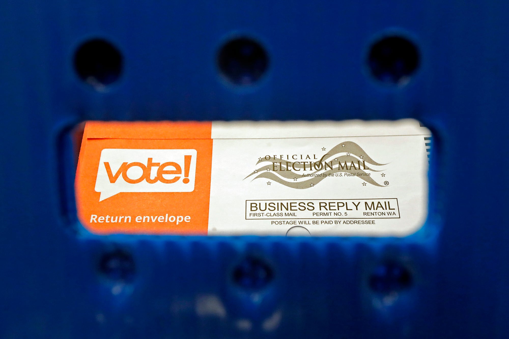 In this Aug. 5, 2020, file photo a vote-by-mail ballot is shown as viewed through the handle of a sorting tray at the King County Elections headquarters in Renton, Wash.