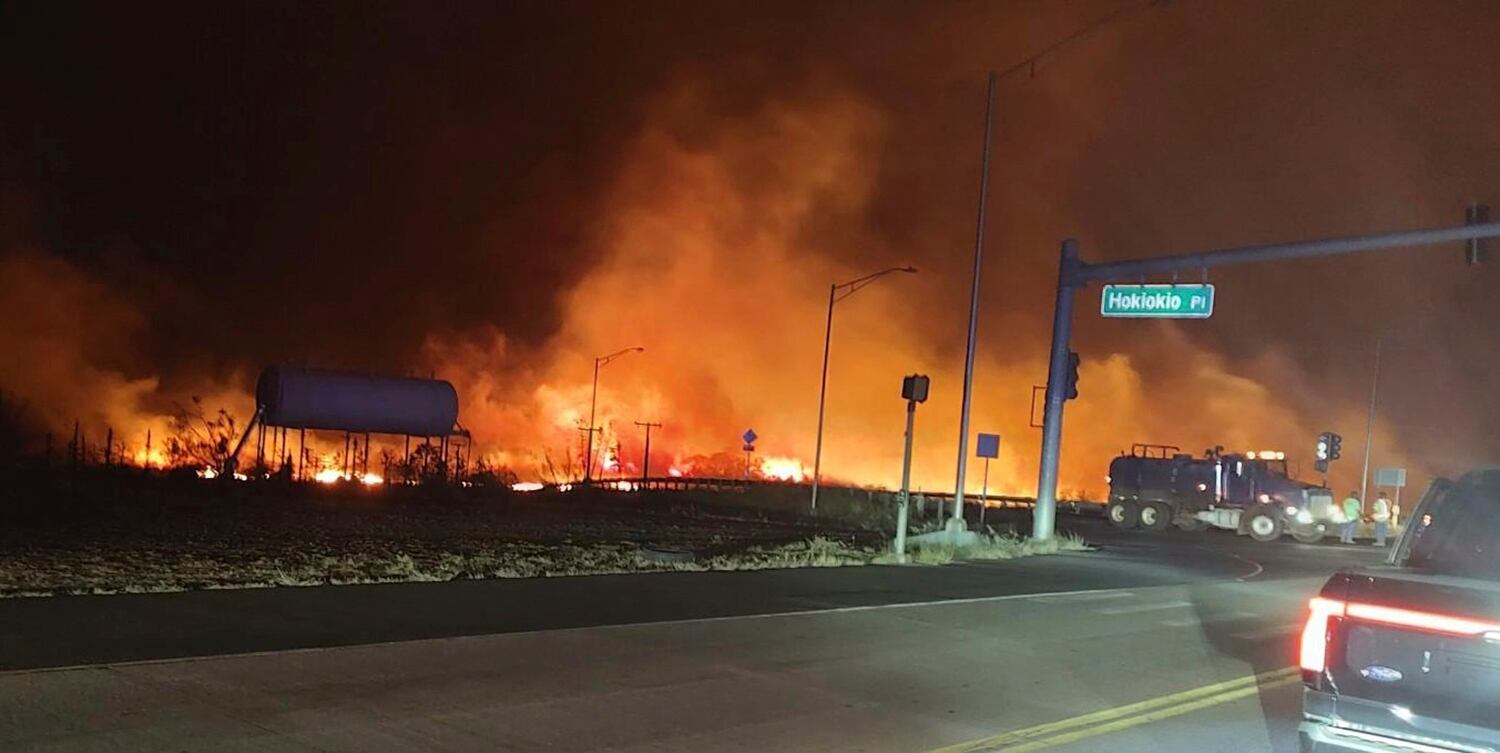 This photo provided by County of Maui shows fire and smoke filling the sky from wildfires on the intersection at Hokiokio Place and Lahaina Bypass in Maui, Hawaii on Tuesday, Aug. 8, 2023.