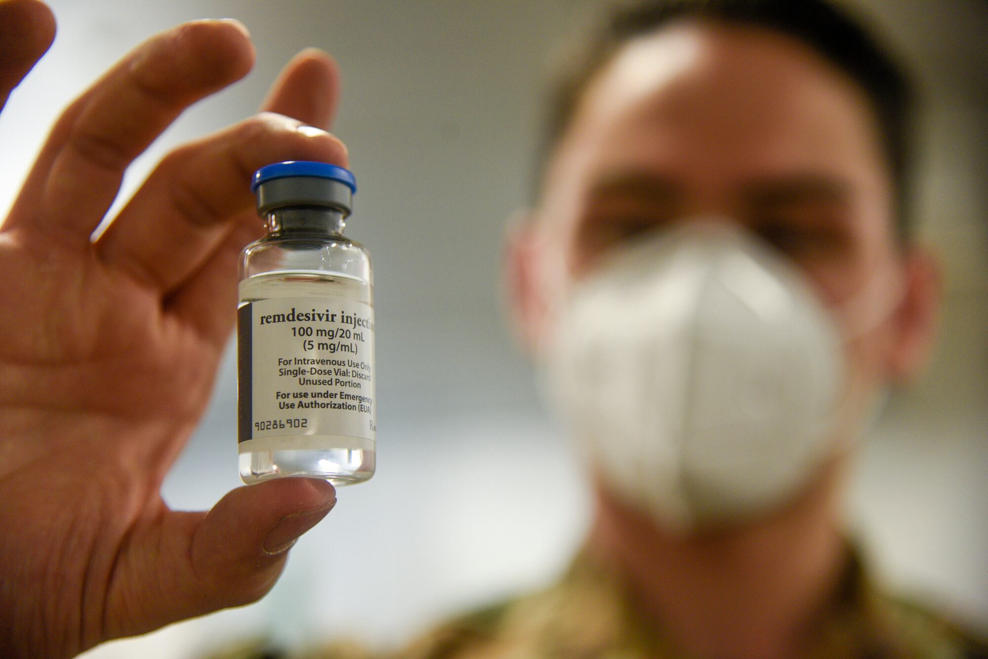 Air Force Airman Robert DuFour holds a vial of Remdesiver, a trial COVID-19 medication, at an undisclosed Strategic National Stockpile warehouse, May 21, 2020.