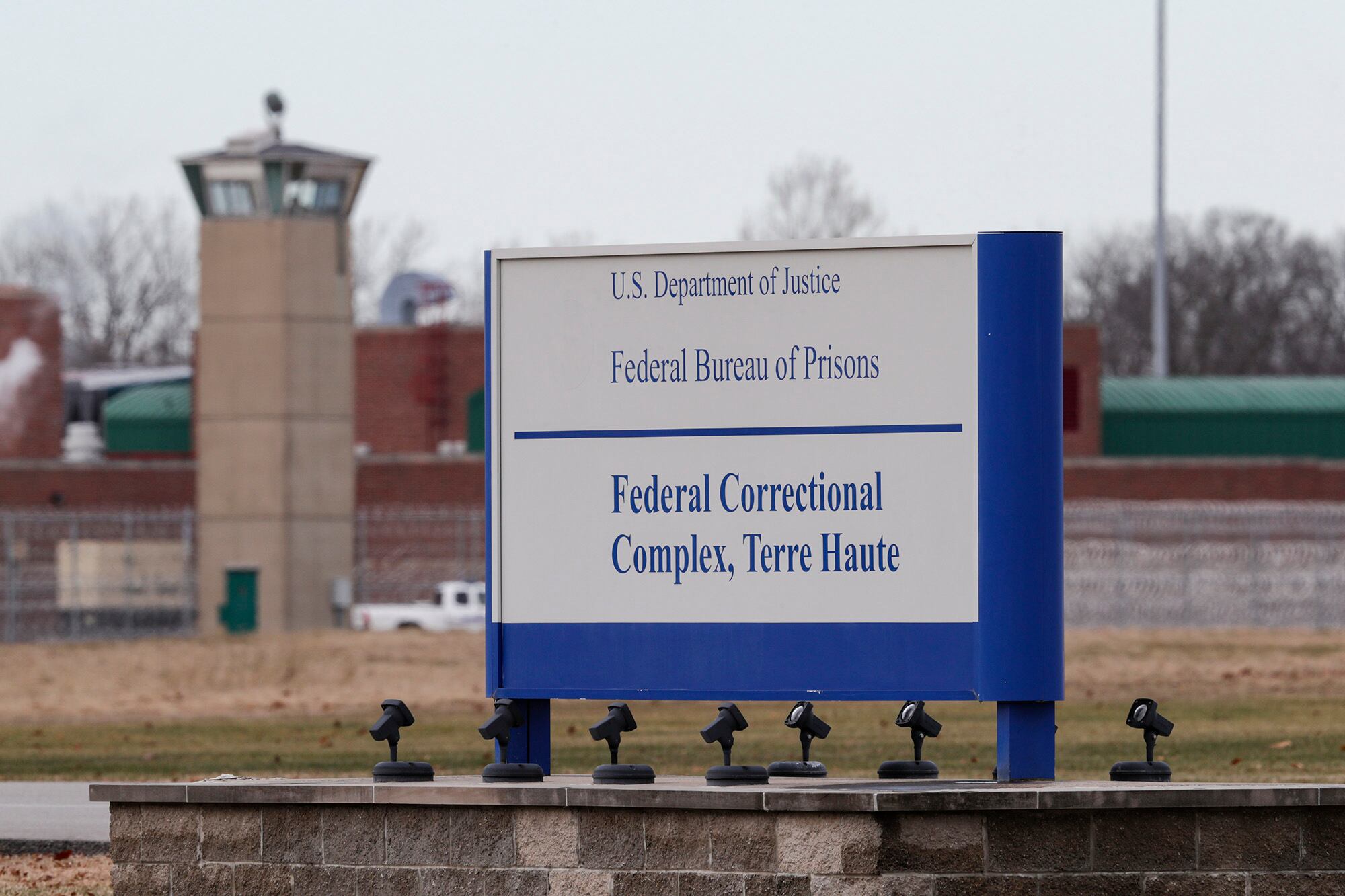 In this Dec. 10, 2019, file photo the guard tower flanks the sign at the entrance to the U.S. Penitentiary in Terre Haute, Ind.